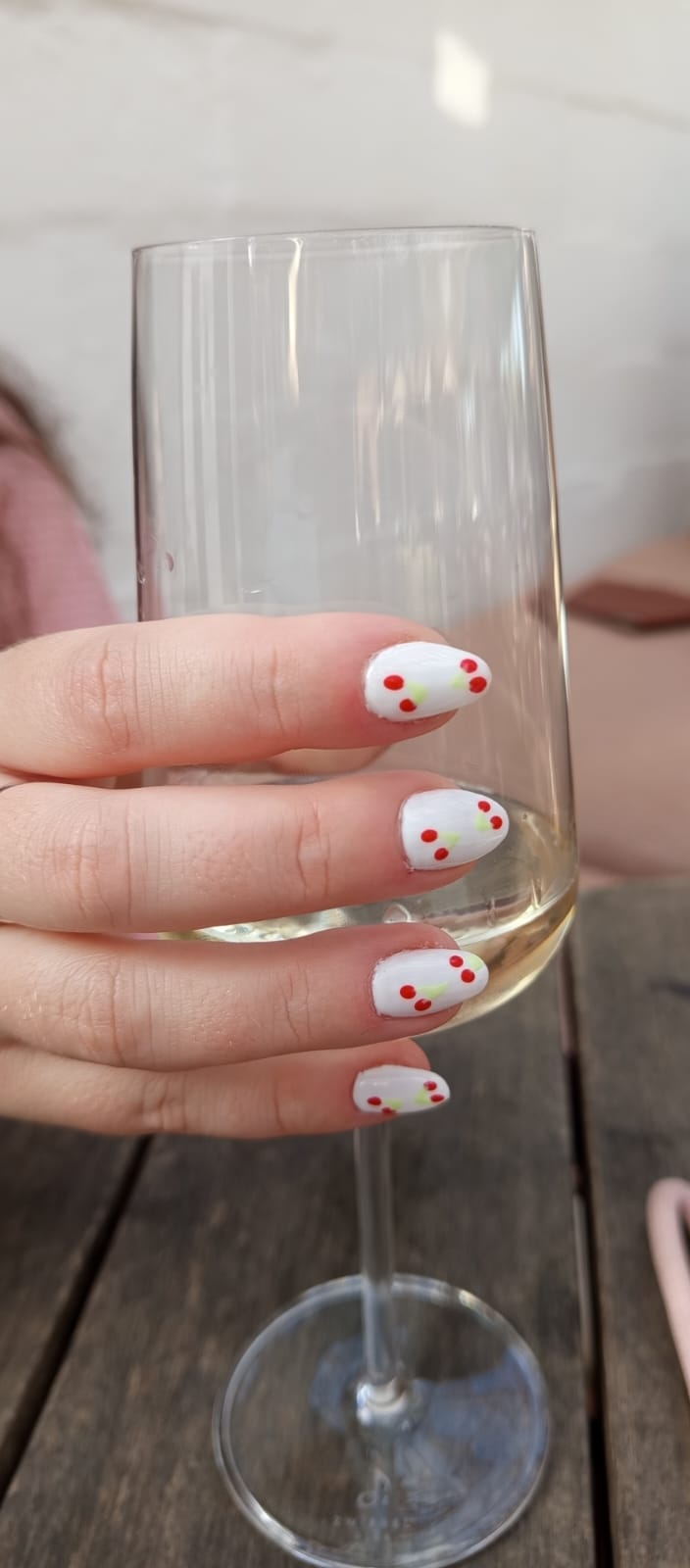 White nails with small red cherry nail art